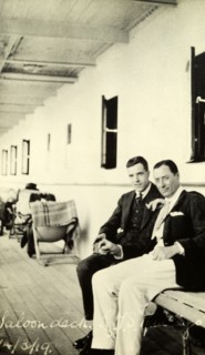 Tamlin on deck. Two gentlemen chat on the saloon deck of a passenger ship. The man on the left is