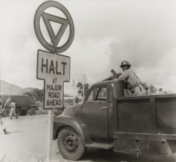 An armed African soldier on the back of truck. An African soldier stands on the back of a