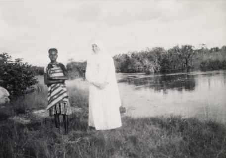 Mother Superior and student. The Mother Superior of the Chilabula Mission, dressed in white from