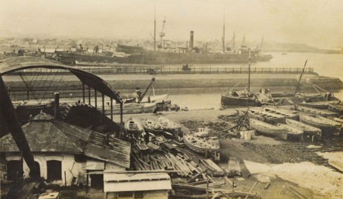 Mazapon Dock, Bombay. View of Mazapon Dock, showing a steamship and fishing trawlers at harbour.