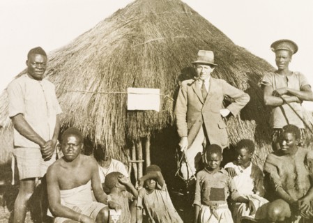 Portrait of workers and children at Balloch Farm. Portrait of a group of male African farm workers,