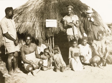 Portrait of workers and children at Balloch Farm. Portrait of a group of male African farm workers,