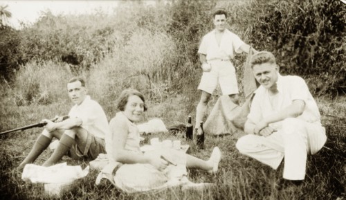 Dr Greta Lowe-Jellicoe enjoys a picnic. Three European men identified as 'Staunton, Ridley and