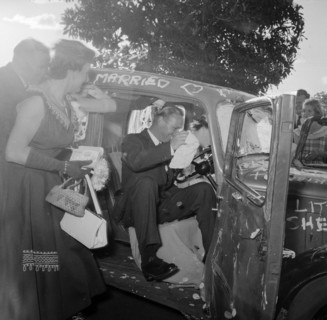Just married. Guests crowd around the newlywed Carey and Courtney couple as they dive into their