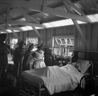 Princess Margaret at a British Military Hospital. Princess Margaret visits the bedside of a young