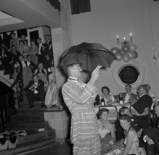 Cabaret act at the Limuru hunt ball. A cabaret performer wearing a flamboyant suit and holding an