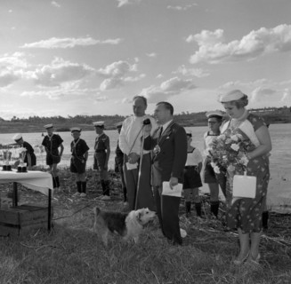 Prize-giving ceremony at the Aquasports Regatta. A small dog takes centre stage as a suited man