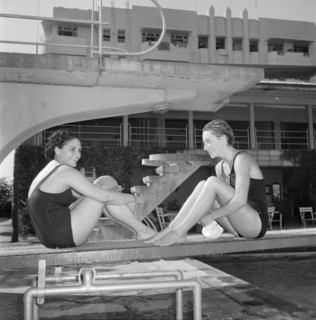 Facing the opposition. Two female swimmers competing in the 1956 Olympic Games sit facing each