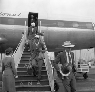 Athletes arrive in Australia. Athletes in the 1956 Kenyan Olympic team descend the steps of an