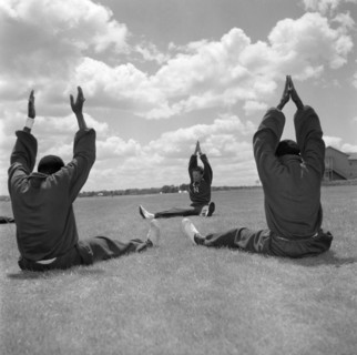Olympic training under Archie Evans. Athletes in the Kenyan Olympic team stretch their arms in the