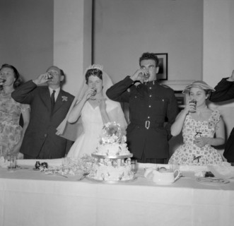 Toasting absent friends. The newlywed Jones and Buckley couple and their family drink a toast to