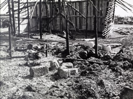 Destruction after a Mau Mau raid. The charred remains of a village destroyed in a raid by Mau Mau