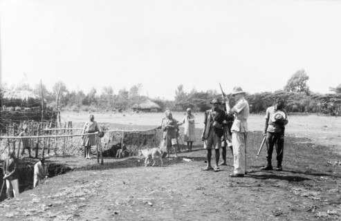 Home Guards at a Kikuyu security village. Armed Kikuyu Home Guards wait for a European man to load