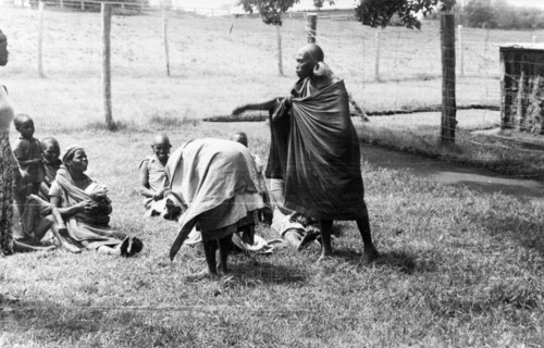 Government de-oathing ceremony. Female Mau Mau detainees undergo a government de-oathing ceremony