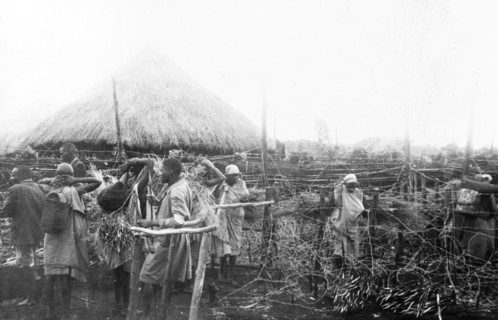 Kikuyu fortified village. Women line up to enter a heavily fortified village past Kikuyu Home