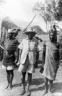 Mau Mau suspect and guards. A Mau Mau suspect under arrest is guarded by two men who stand either