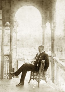 Dr Taylor relaxes at 'Nundora'. A well-dressed gentleman identified as 'Dr Taylor' relaxes with a