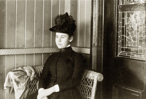 Laura Hart' on the veranda. Portrait of a Victorian lady identified as 'Laura Hart'. Dressed in a