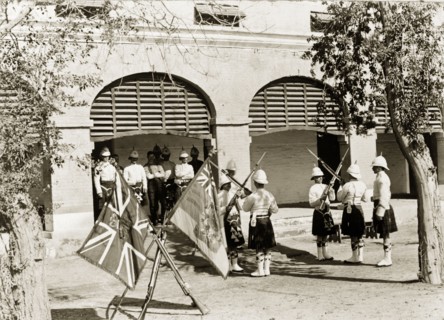 Relieving sentries. Uniformed sentries from a Scottish regiment cross their bayonets as they