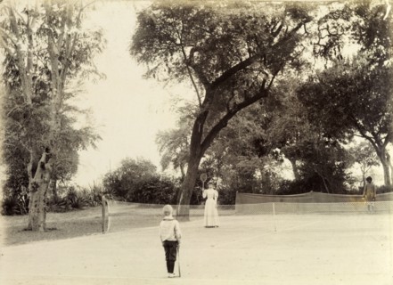 Mrs Page plays tennis. A British women identified as 'Mrs Page' holds up her tennis racquet towards