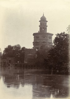 Ornate Hindu temple. An ornate Hindu temple perched on the edge of a lake is silhouetted against