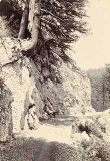 The road to Ghanal. Several figures on the road to Ghanal, a narrow track cut into the side of a