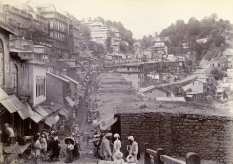 Bustling market street at Murree. Shop awnings line a bustling market street that winds down from