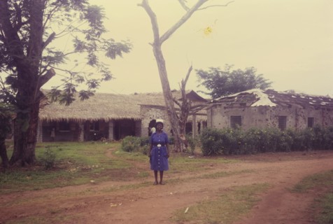 Matron Ifeka at Iyi Enu. A nurse in uniform identified as 'Matron Ifeka' stands outside the Iyi Enu