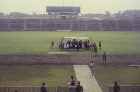Thanksgiving ceremony, Nigeria. A group of Christian priests gather beneath a small canopy at