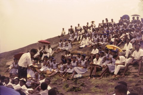 Student union picnic, Nigeria. Uniformed students from a Church of Nigeria college sit on a