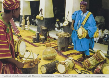 Talking drums', Nigeria. A colourful tourist postcard depicts two Nigerian drummers playing on