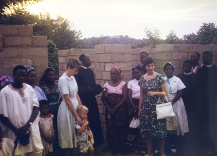 An Archdeacon blesses a new ward. An Archdeacon reads from the bible as he blesses the construction