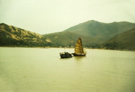 Chinese gun boat. A Chinese gun boat off the coast of Macau sails alongside a traditional Chinese