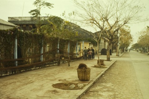 Hanging ropes in Macau. A small group of people unwind lengths of rope from baskets on the