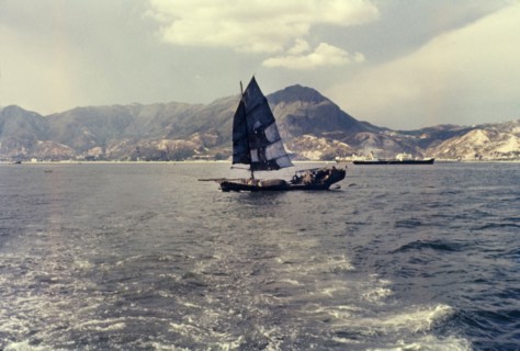A Chinese junk. A Chinese junk pictured against mountains looking towards Kai Tak. Kai Tak, Hong
