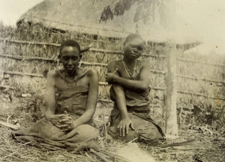 Sufferers from sleeping sickness, Uganda. A man and a woman dressed in bark cloth are seated