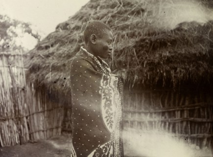 Ugandan woman. Profile shot of a Ugandan woman wrapped in a patterned cloth. Uganda, 1906. Uganda,