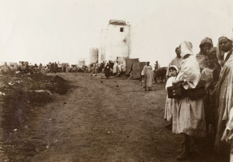 City walls of Casablanca. Crowds line a dirt track running past the city walls. Casablanca,