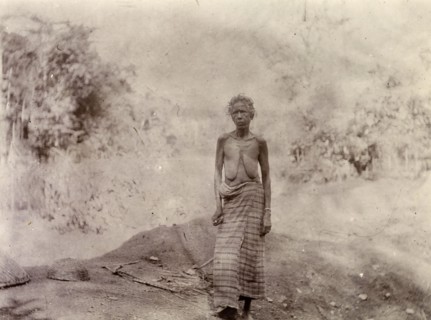 Woman rural labourer, Morocco. Outdoors portrait of a thin, elderly woman. She wears a long cloth