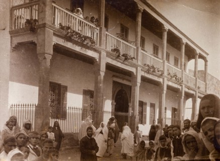 Russi's house' in Safi. Crowds of people stare in wonderment at the camera beside a large