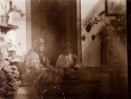 Mrs Russi dressed as a 'moorish woman'. Mrs Russi, a European woman, sits in the doorway of a