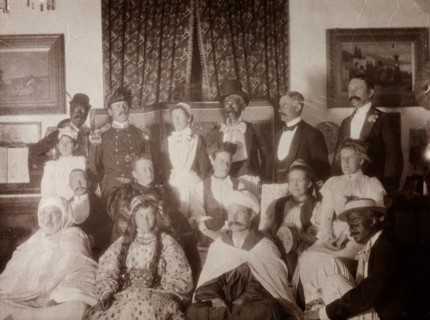 European fancy dress party, Morocco. Interior shot of European men and women dressed up in variety