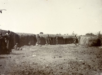 Outside a Maasai village. A group of Maasai are pictured outside the protective mud wall of their