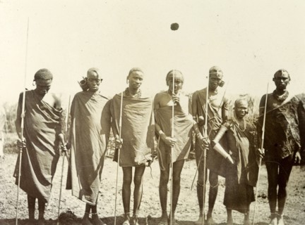 Maasai youths. A group of Maasai youths line up for the camera wearing traditional dress and