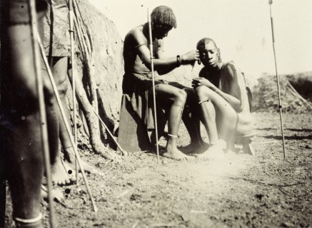 Maasai hairdressing. Maasai society is ordered by age groups and the young men shown here probably