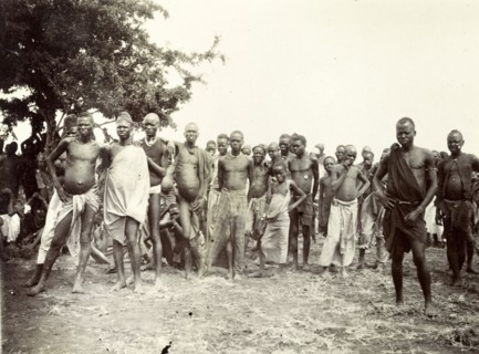 Nyamwezi porters. A crowd of male Nyamwezi porters stand, staring into the camera. German East