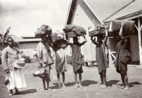 Porters at the station. Frederick Stanbury's safari porters balance large bundles of luggage on