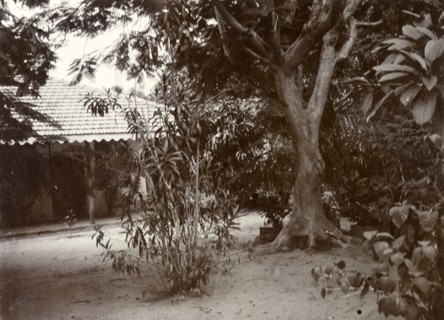 Resthouse at Nakuru. The doorway of a single storey building seen through trees, identified in the