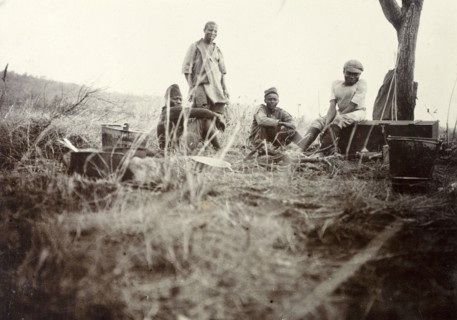 Safari camp 'kitchen'. African cooks and servants pictured outdoors in a makeshift 'kitchen' at