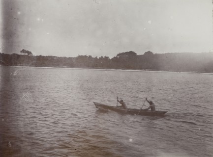 Canoe on Lake Victoria. Two men paddle a small wooden canoe on Lake Victoria. Lake Victoria,